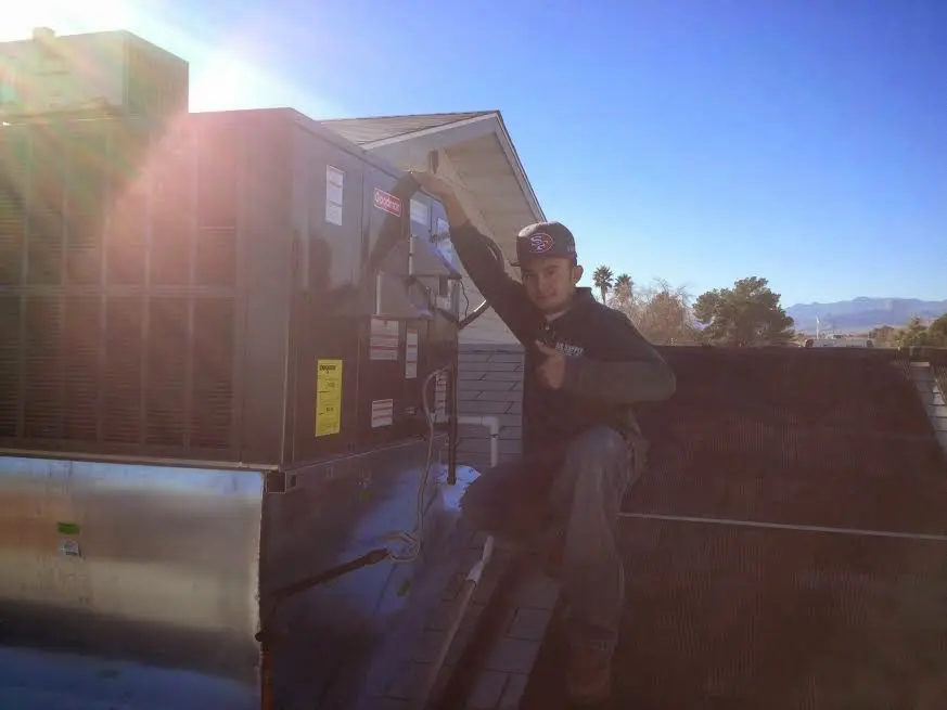 HVAC technician performing HVAC Inspection on a rooftop unit in Woods Cross